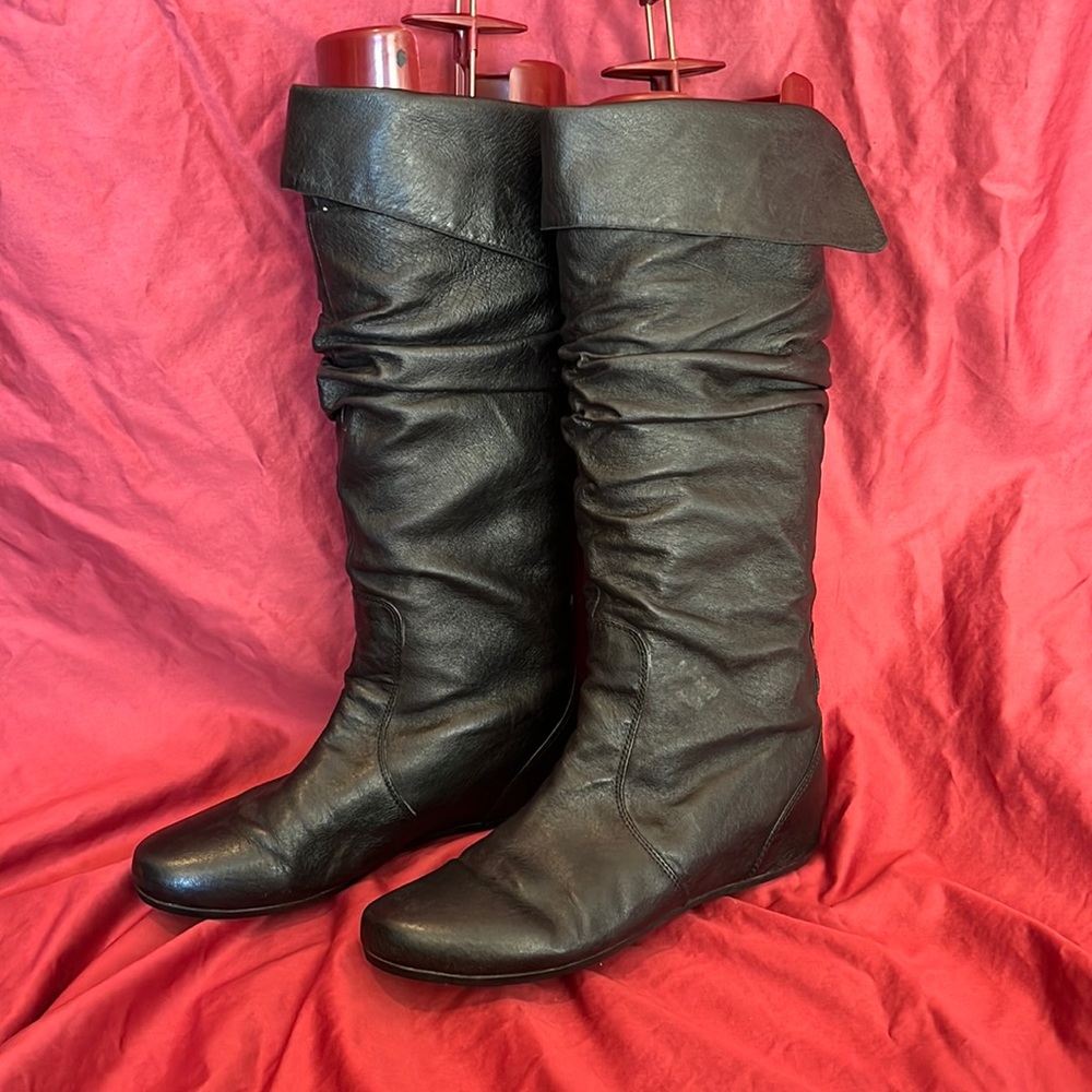black leather knee high boots.  Flat soles foldover details at top of boots